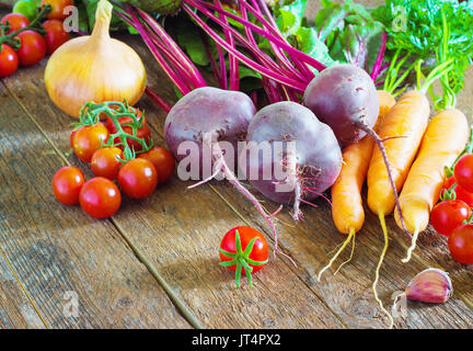 ingredients for pasta on a wooden table, cherry tomatoes and pasta Stock Photo