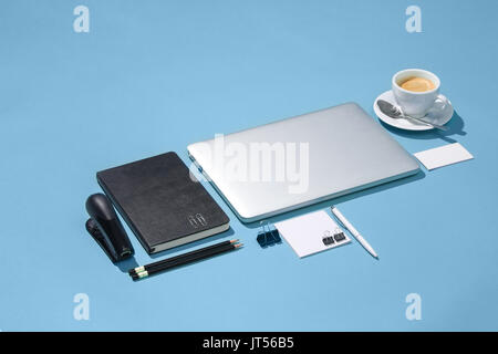 The laptop, pens, phone, note with blank screen on table Stock Photo