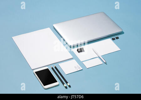 The laptop, pens, phone, note with blank screen on table Stock Photo