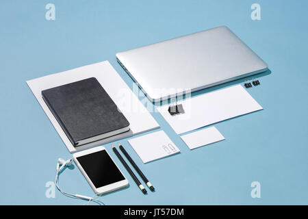The laptop, pens, phone, note with blank screen on table Stock Photo