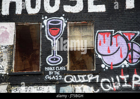 Hackney Wick. The Lord Napier, a disused pub, covered in graffiti. detail of a painted wine glass, captionned 'Middle class by the glass'. Stock Photo