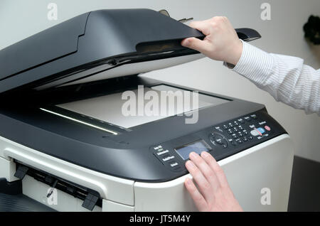 Man using scanner multifunction device in office Stock Photo