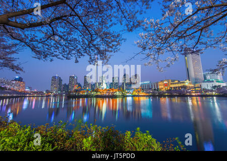 SEOUL, KOREA - APRIL 9, 2015: Lotte World amusement park at night and cherry blossom of Spring, a major tourist attraction in Seoul, South Korea on Ap Stock Photo