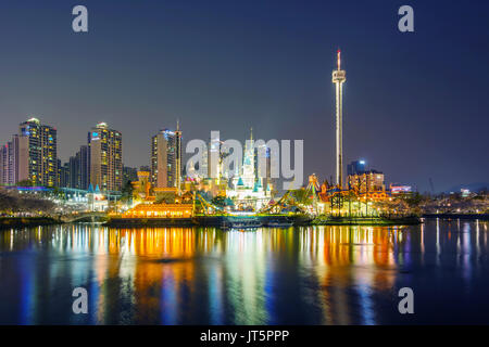 SEOUL, KOREA - APRIL 9, 2015: Lotte World amusement park at night and cherry blossom of Spring, a major tourist attraction in Seoul, South Korea on Ap Stock Photo