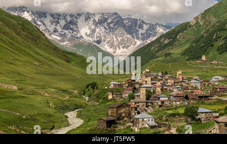 Panoramic view of village Ushguli with old stone towers under the highest georgian mountain Shkhara with glacier in Svaneti, Caucasus, Georgia Stock Photo