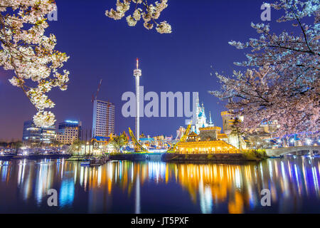 SEOUL, KOREA - APRIL 9, 2015: Lotte World amusement park at night and cherry blossom of Spring, a major tourist attraction in Seoul, South Korea on Ap Stock Photo