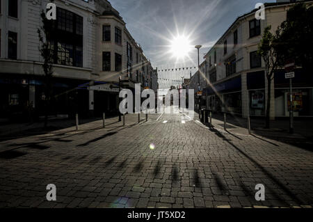 Sun setting over Worthing high street in West Sussex Stock Photo