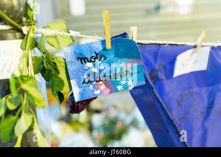 a note with words of love, mots d'amour. Spontaneous homage at the victims of the terrorist attacks in Paris the 13th of november 2015. Stock Photo