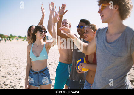 Group of friends playing at beach volley at the beach Stock Photo