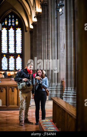 NEW YORK, USA - October 14, 2016. Two Photographers Visiting Inside of Trinity Church Located on Wall Street and Broadway, Manhattan, New York. Stock Photo