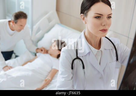 Beautiful smart doctor studying an X ray photo Stock Photo