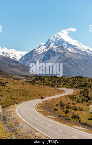 Curvy road with view to Mount Cook, snow covered mountains, Mount Cook National Park Southern Alps, Canterbury, South Island Stock Photo