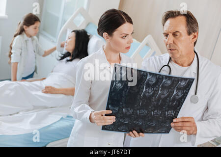 Professional experienced doctors looking at the Xray photo Stock Photo