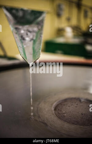 Closeup of Silica Sanding Table Spinning (motion Blur) and water drooping Stock Photo
