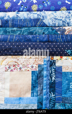 garment manufacturing, sewing, creativity, handiwork, decoration, arts and crafts cocnept - textile applique made of different in forms and colores patches with various nice patterns Stock Photo