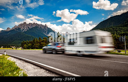 Family vacation travel, holiday trip in motorhome, Caravan car Vacation. Beautiful Nature Italy natural landscape Alps. Stock Photo