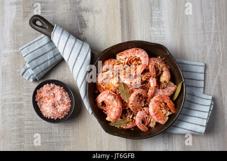Cooked red shrimp on a light background. Prepared in a frying pan Stock Photo