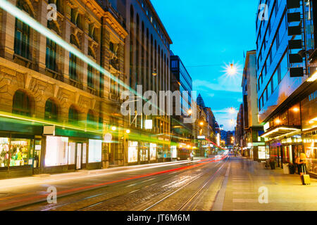 Helsinki, Finland. Tram Departs From A Stop On Street Aleksanterinkatu In Helsinki. Night View Of Aleksanterinkatu Street In Kluuvi District In Evenin Stock Photo