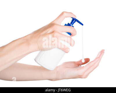 Woman hands pushing soap dispenser with soap drop. Isolated on white, clipping path included Stock Photo