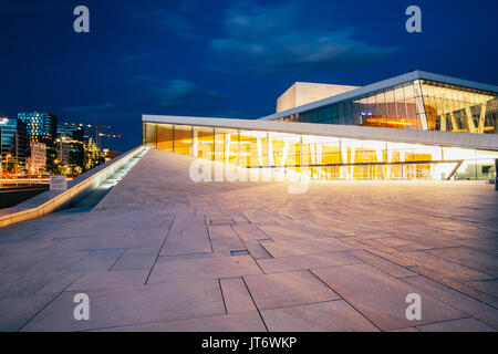 Oslo, Norway - July 31, 2014: The Side View Of Brightly Illuminated Glass Facade Of Norwegian National Opera And Ballet House In Summer Evening, Blue 