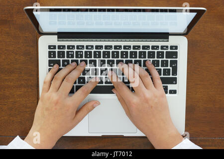A person's hands using a laptop. Stock Photo