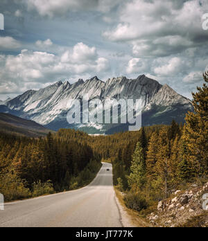 Scenic view of the road and canadian rockies on Icefields Parkway. It travels through Banff and Jasper National Parks and offers spectacular views of  Stock Photo