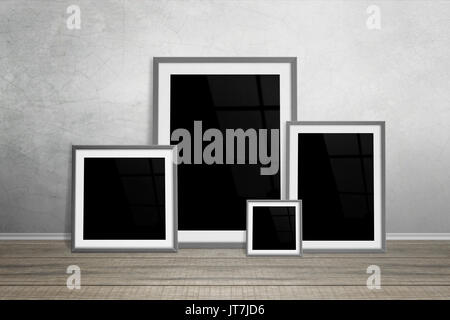 Multiple frames leaning on wall. Isolated for mockup. Stock Photo