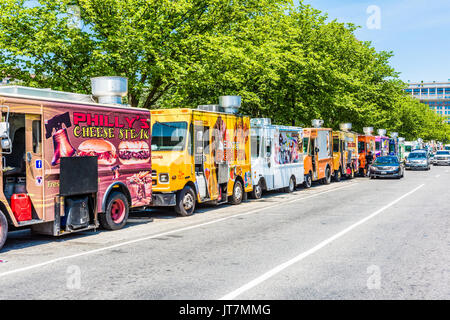 Washington DC, USA - July 3, 2017: Food trucks on street by National Mall with cars driving by on Independence Avenue Stock Photo