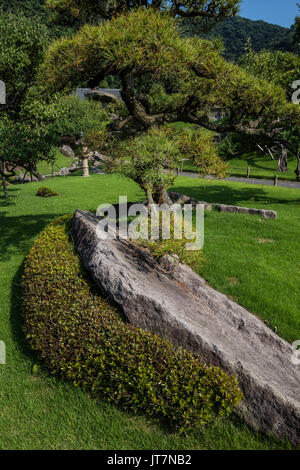 Sengan-en Garden is a  daimyo strolling garden in Kagoshima. It's most striking feature is its use of the volcano at Sakurajima beyond Kagoshima Bay a Stock Photo