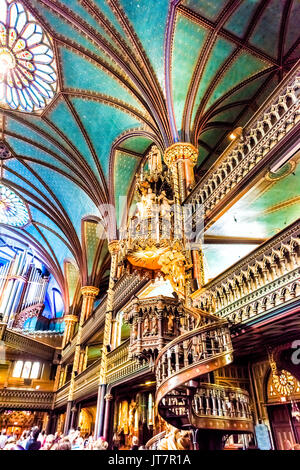 Montreal, Canada - May 28, 2017: Inside Notre Dame Basilica during mass with many people taking pictures of detailed architecture Stock Photo
