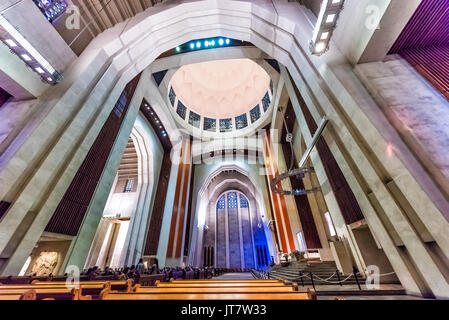 Montreal, Canada - May 28, 2017: Inside St Joseph's Oratory on Mont Royal tall walls and stained glass murals in Quebec region city with people sittin Stock Photo