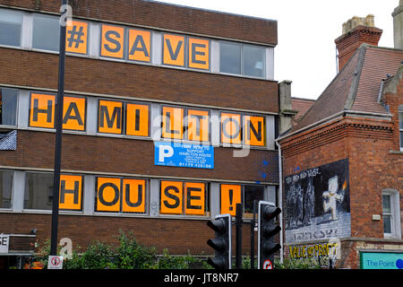 Bristol, UK. 8th August, 2017. New graffiti appears as part of the campaign to save Hamilton House in the Stokes Croft area of the city. Hamilton House is a former office block which serves as a community hub and provides studio and office space for over 200 small businesses, but its future is currently in doubt as the owners of the building have announced plans to develop it and intend to seek vacant possession. Keith Ramsey/Alamy Live News Stock Photo