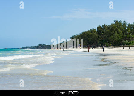 Tropical beach with people and palm trees in background, Diani, Kenya Stock Photo