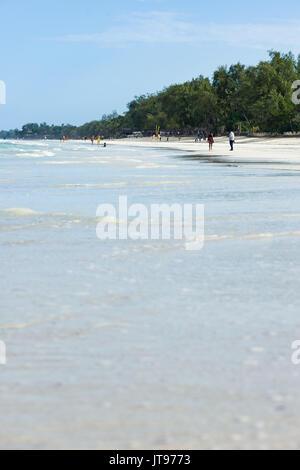 Tropical beach with people and palm trees in background, Diani, Kenya Stock Photo