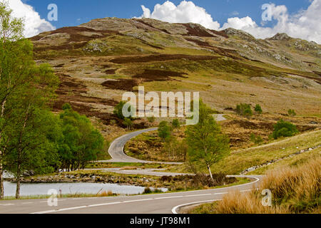 Road winding through rugged & mountainous Scottish highland landscape near Fort Augustus, Scotland Stock Photo