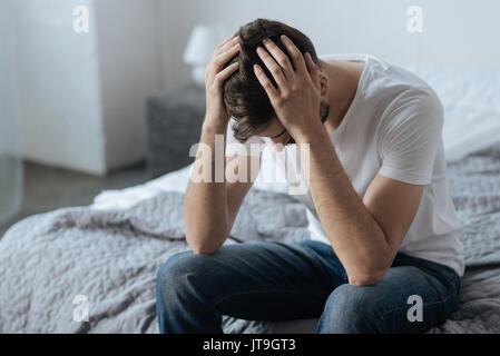 Unhappy handsome man feeling upset Stock Photo