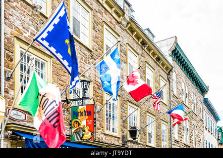 Quebec City, Canada - May 29, 2017: Old town street Rue Couillard with flags by Portofino restaurant Stock Photo