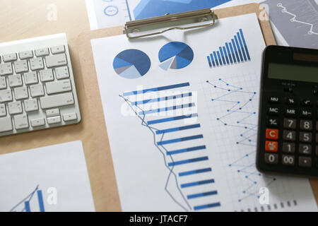 Business reports  Teamwork on table report  of documents Blue graphs and charts financial paperwork and reports Stock Photo
