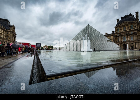 The large pyramid in the main courtyard and the main entrance to the Louvre Museum, Paris, France, Europe Stock Photo