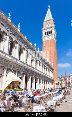 Campanile tower, Piazzetta, and tourists enjoying the cafes of St. Marks Square, Venice, UNESCO, Veneto, Italy, Europe Stock Photo