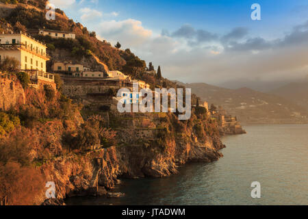 Sunrise lights up villas, misty dawn on the Amalfi Coast, near Atrani in spring, UNESCO, Campania, Italy, Europe Stock Photo
