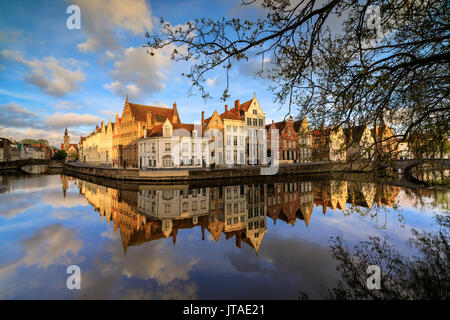 Pink clouds at dawn on the Belfry and historic buildings reflected in the typical canal, Bruges, West Flanders, Belgium, Europe Stock Photo