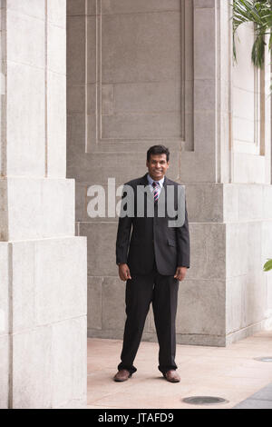 Indian business man in Asian city. Portrait of an Asian businessman smiling & looking at the camera. Stock Photo
