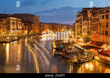 Grand Canal at night with boat light trails and moored gondolas, on the Fondementa del Vin, UNESCO, Venice, Veneto, Italy Stock Photo