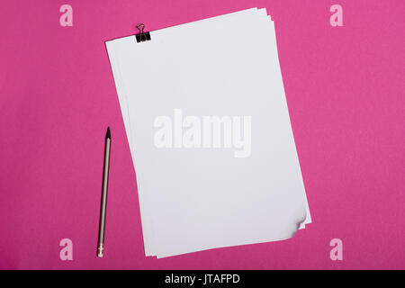 Top view of blank white papers and pencil isolated on pink Stock Photo