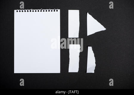 directly above view of arranged ripped papers isolated on black Stock Photo