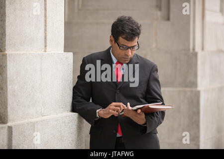 Indian business man with a tablet computer. Asian business man using digital tablet computer. Stock Photo