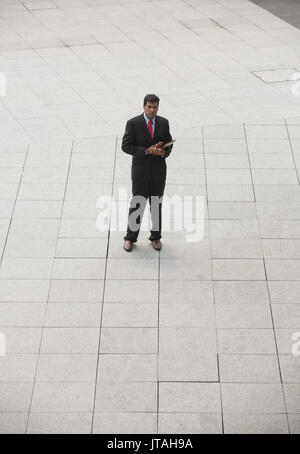 High angle view of a happy Indian businessman looking at the camera. Stock Photo