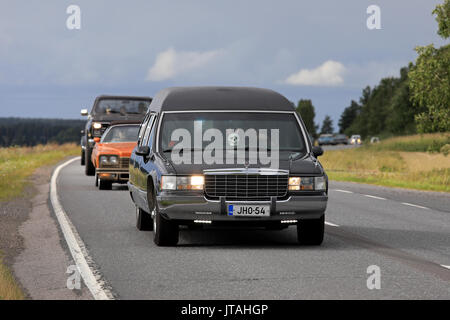 SOMERO, FINLAND - AUGUST 5, 2017: Tuned Cadillac Fleetwood funeral car with led lights and skull detail moves along scenic highway on Maisemaruise 201 Stock Photo