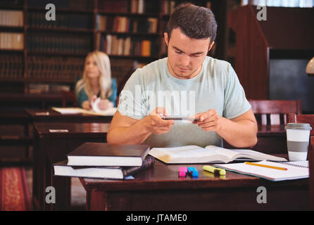 Male studying with his smartphone Stock Photo